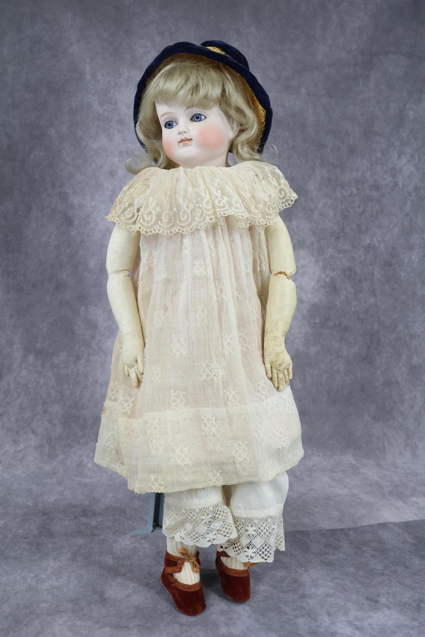 ANTIQUE GERMAN CLOSED MOUTH BISQUE HEAD DOLL(S).: 20" Unmarked turned shoulder shoulder head doll with beautiful bisque. Stationary blue eyes, blonde mohair wig, plaster pate. Leather gusseted body with individual fingers. Dressed in antique white co