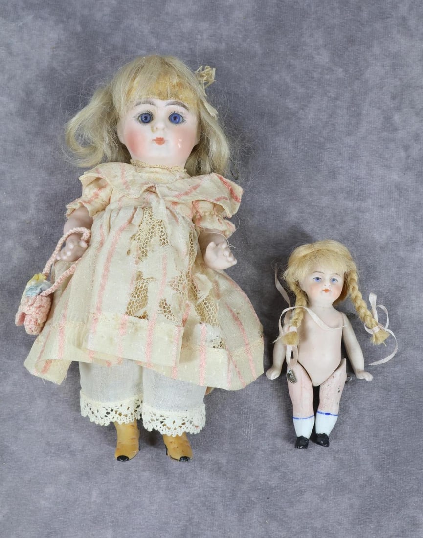 GERMAN ALL BISQUE DOLL(S).: Pair of dolls. Both dolls have blonde mohair wigs, closed mouths. 7" 206 8 Doll with stationary blue eyes, swivel neck, 5 pc . body. Painted yellow boots. Dressed in antique silk dress, cotton underwe