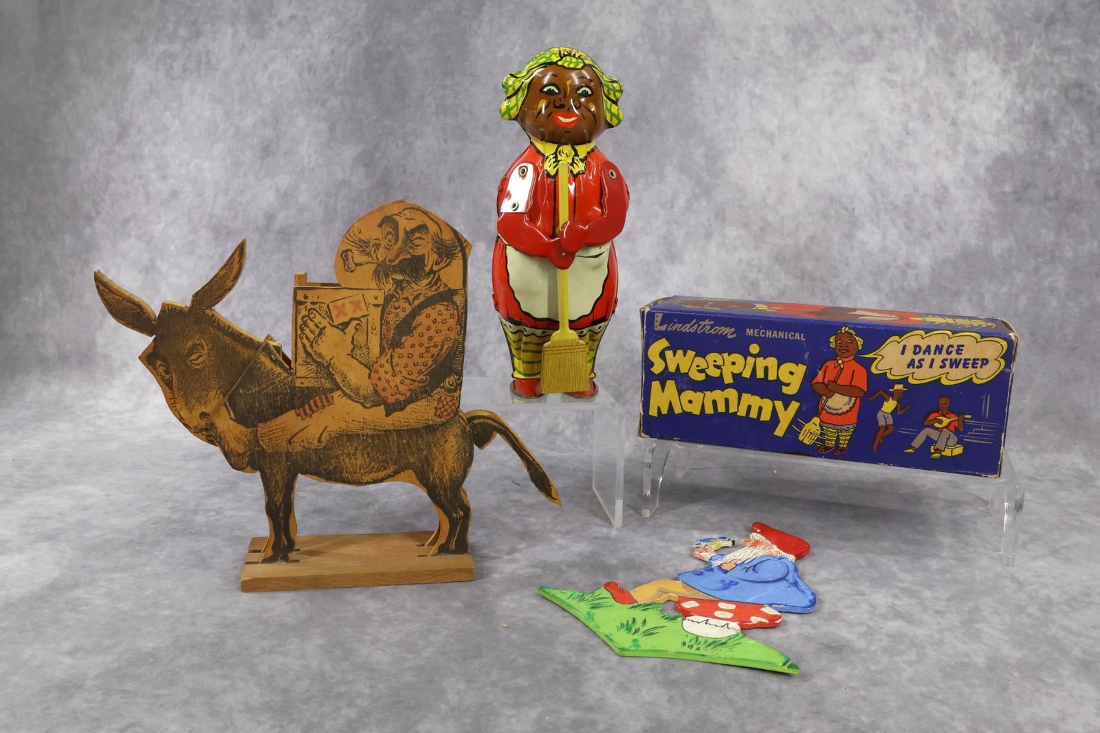 TOYS.: LOT. 8" Lindstrom Mechanical "Sweeping Mammy" metal wind-up toy in OB, No. 1750, Bridgeport, CT. When wound, she dances around in a circle and sweeps. Condition: In good working order. Box end has bee