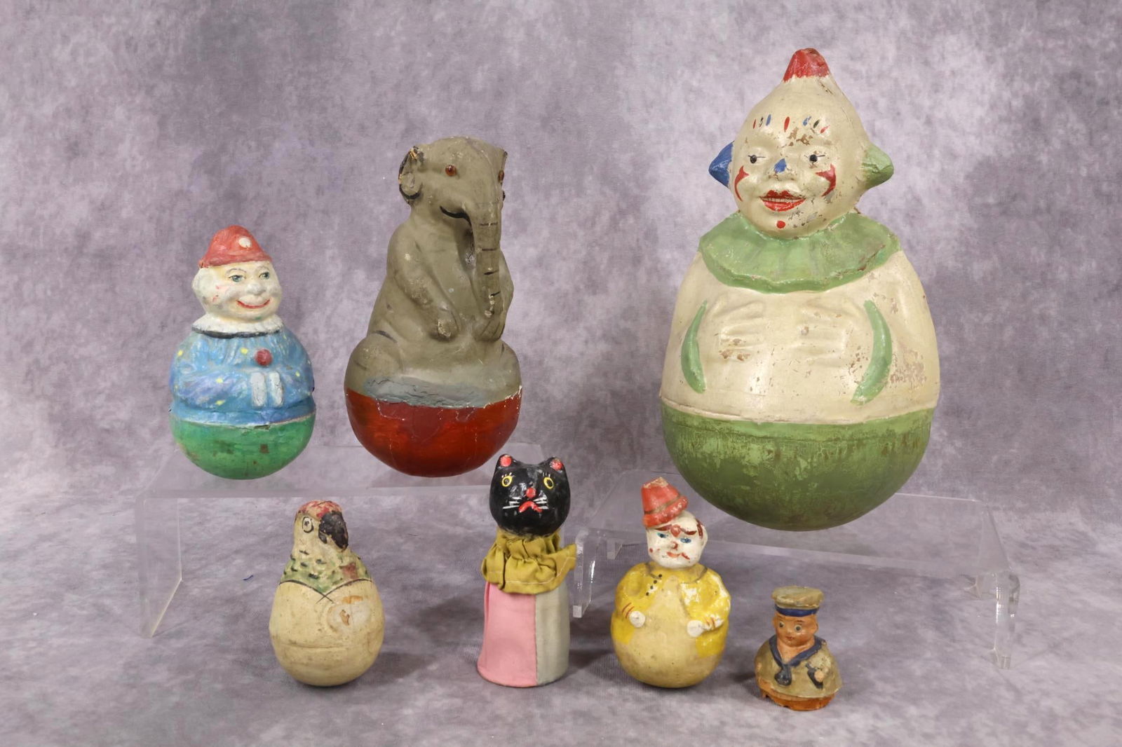 TOYS.: LOT. (5) Unmarked papier mache Roly-Dolys. 3 1/2" Parrot. 3 3/4" Clown. 5" Clown. 7" Elephant with amber glass eyes. 10" Clown. Condition: all of them have crazing, paint loss. ALSO - TOP only of a 2