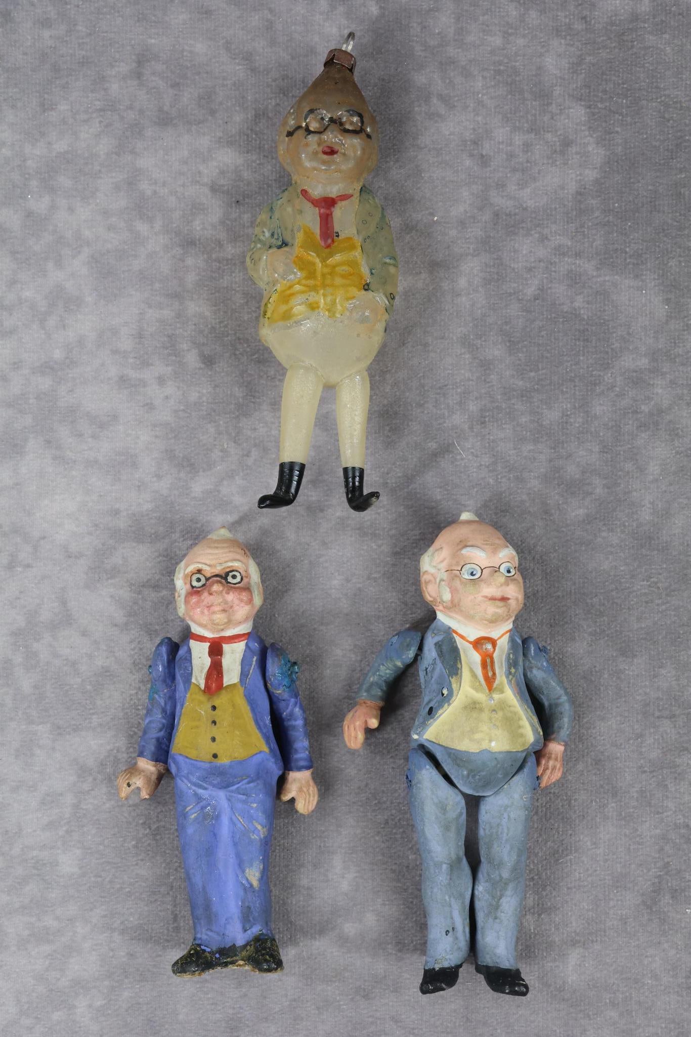 NOVELTIES/HOLIDAY.: NOVELTY/HOLIDAY - LOT of "Foxy Grandpa". 4 1/2" Glass Christmas ornament. with annealed legs. Painted wire rim glasses, blue jacket with yellow vest. Condition: paint is worn, small break at stem top.