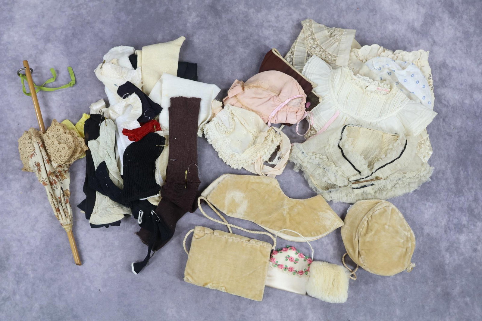 ANTIQUE DOLL/BABY ACCESSORIES.: LOT. Baby - (4) bonnets of cotton and silk. (2) Collars, ruffled and embroidered. (1-for a child). Doll - capelet with bar pin. (2) Silk bonnets, (1) cotton. 3 Pc. ivory velveteen set of hat, collar a
