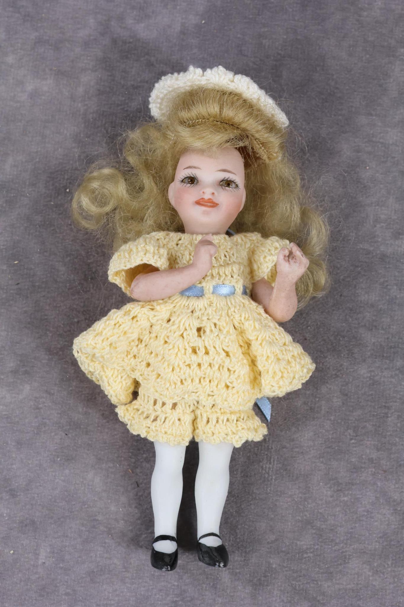 GERMAN ALL BISQUE DOLLS.: ORSINI Character girl with glass eyes. 5" "DiDi" Doll marked with paper label on chest. Label reads Copr. 1920 J.J. Orsini. Marked on back J.J.O (copyright) 1920 41. Stationary brown eyes, blonde curl