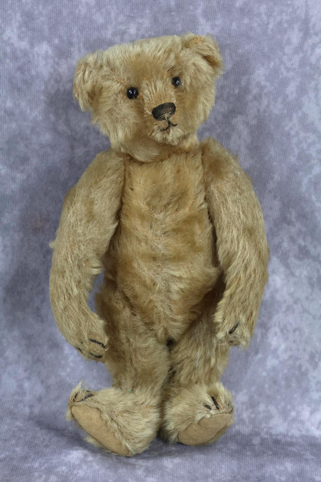 TOYS, VINTAGE STEIFF.: 10" STEIFF camel mohair bear. Fully jointed with swivel head, black shoe button eyes. Hump on back. Marked with silver BLANK button Condition: minor age discoloration otherwise, nothing observed. This