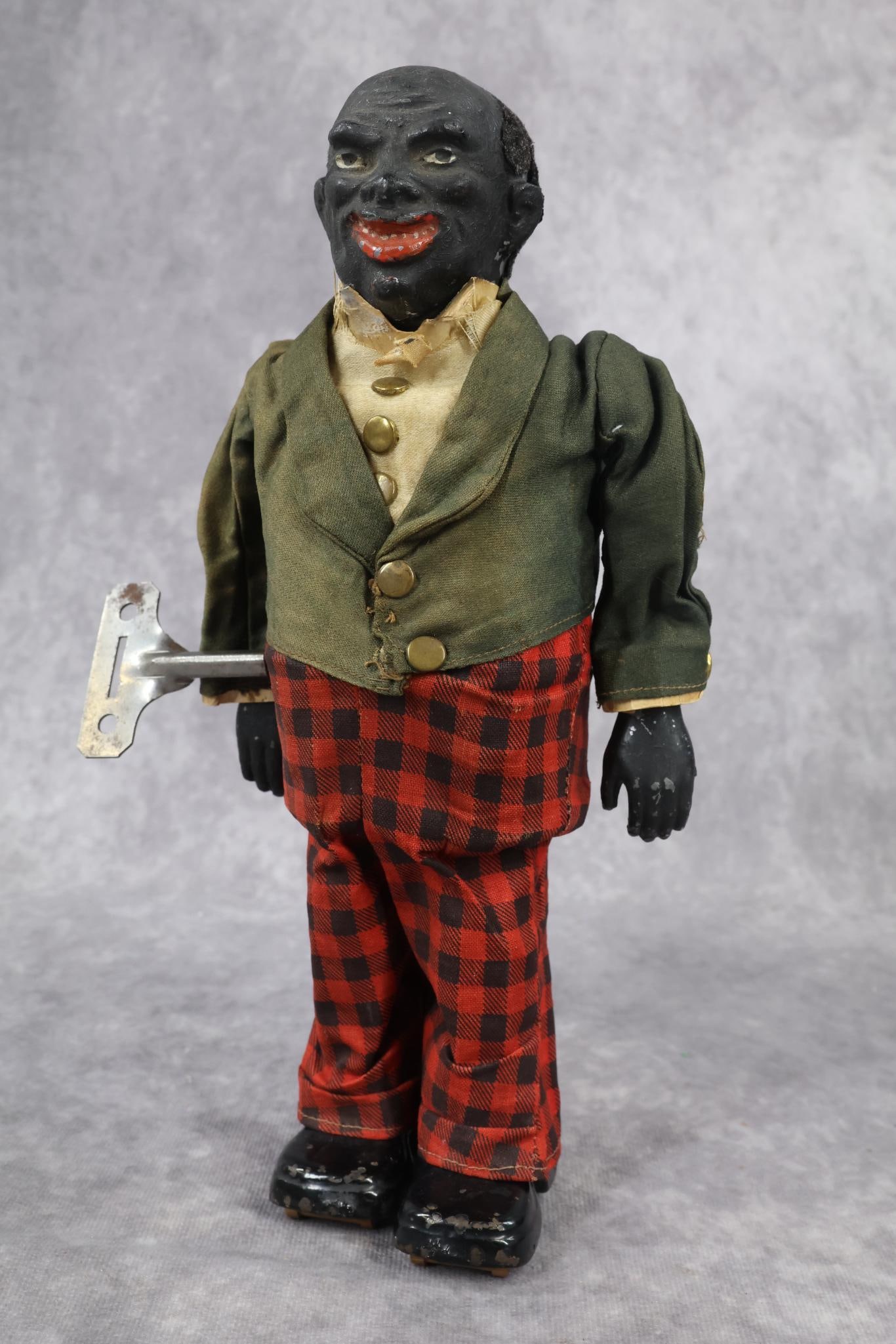 TOYS, IVES.: 10" IVES "Old Black Joe" Walker. Clockwork, in good working condition. Clothing appears to be all original. He has his key. Condition: clothing has age discoloration, fading. "Tear" in the hair area. 