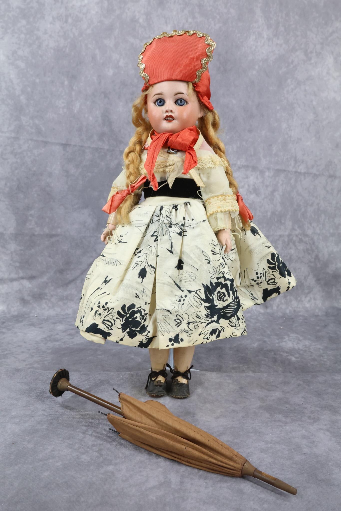 ANTIQUE FRENCH BISQUE HEAD DOLL.: 14" D SFBJ 60 PARIS 3/0 Doll with blue sleep eyes, open mouth, strawberry blonde mohair braided wig. Papier mache jointed body. Dressed in vintage dress with a nylon bodice and cape. Cotton print skir