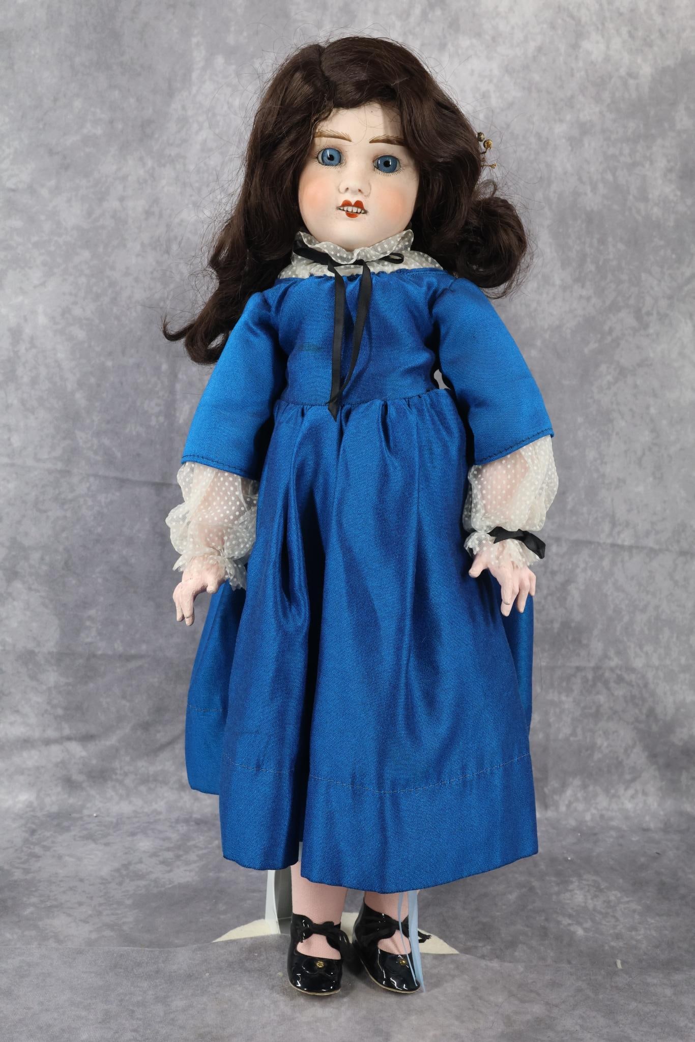 ANTIQUE FRENCH BISQUE HEAD DOLL.: 23" PETITE FRANCAISE J V (Verlingue - anchor symbol) 9 LAINE? (mark is very hard to read). Doll has stationary blue eyes, open mouth, synthetic wig. Papier mache jointed body. Dressed in newer clothin