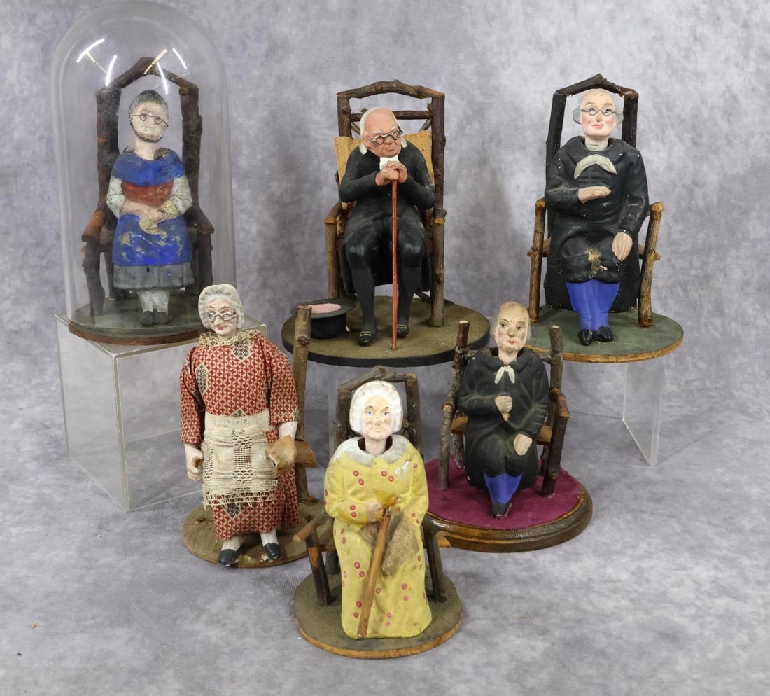 ANTIQUE NODDERS.: LOT of (5) antique German? papier mache nodders and (1) stationary man in chair. Nodders - ((2) Men, (3) Women sitting on twig chairs. (1) Has a glass dome. Stationary man - 6" T resembles Benjamin Fr