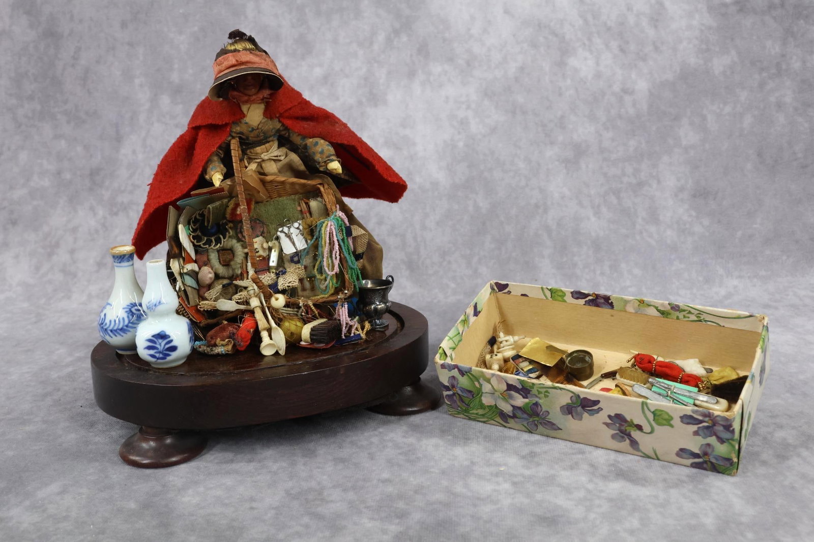 PEDDLER DOLL.: 7" Wax Peddlar Lady, England, mid-19th C. This item came from the Richard Wright Collection Auction, 2009. Wax figure of an elderly lady peddler with painted features. She has her original costume wit