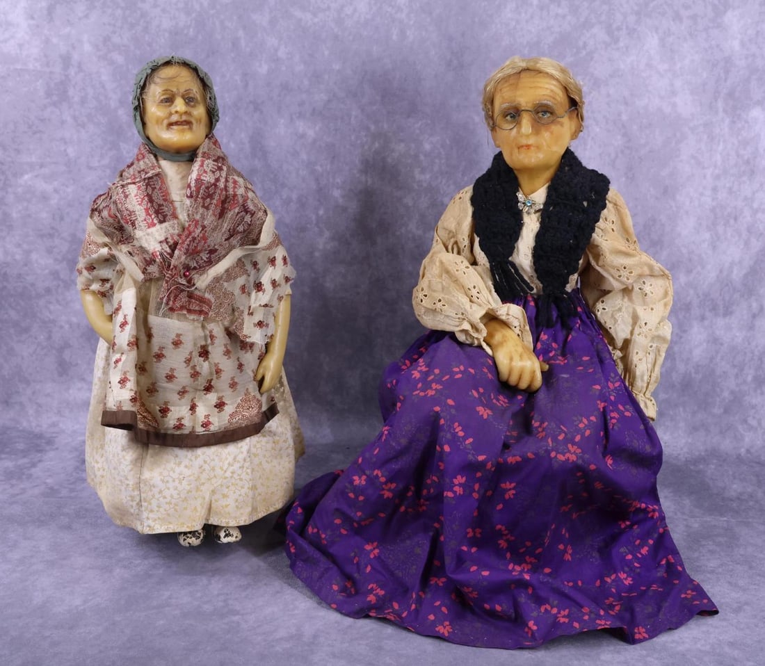 WAX HEAD DOLLS.: Pair of Elderly Female character dolls. Both dolls have wax heads, hands, painted features and are dressed in antique clothing. Doll 1) 16" T, is the older of the two dolls. She has wisps of human hai