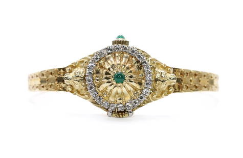 14kt YG Ladies Faberge Wrist Watch: Franklin Mint and Igor Carl Faberge, c.1981, limited edition of 2500, the hinged cover set with 24 diamond melee and a cabochon emerald, the face with 4 faceted emeralds, marked Igor Carl Faberge, cab