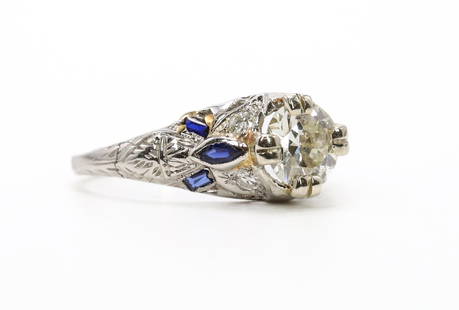 14k WG Diamond and Sapphire Ring: 14k white gold diamond ring set with an approx. .75 carat round cut diamond with diamond accents and also marquise and baguette cut sapphires. 5.75" and 1.6dwt