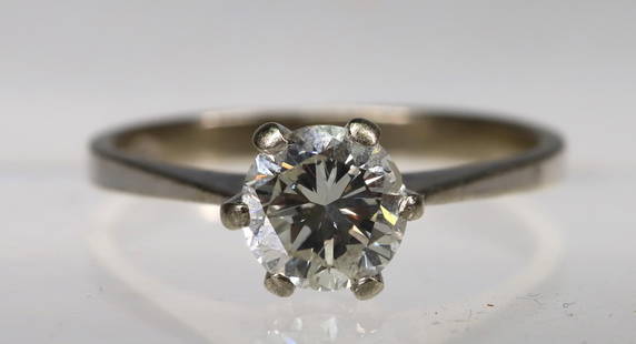 18k WG Diamond Solitaire: 18k white gold setting with an approx. 1 carat round brilliant cut solitaire. Size 7 and 2.0dwt