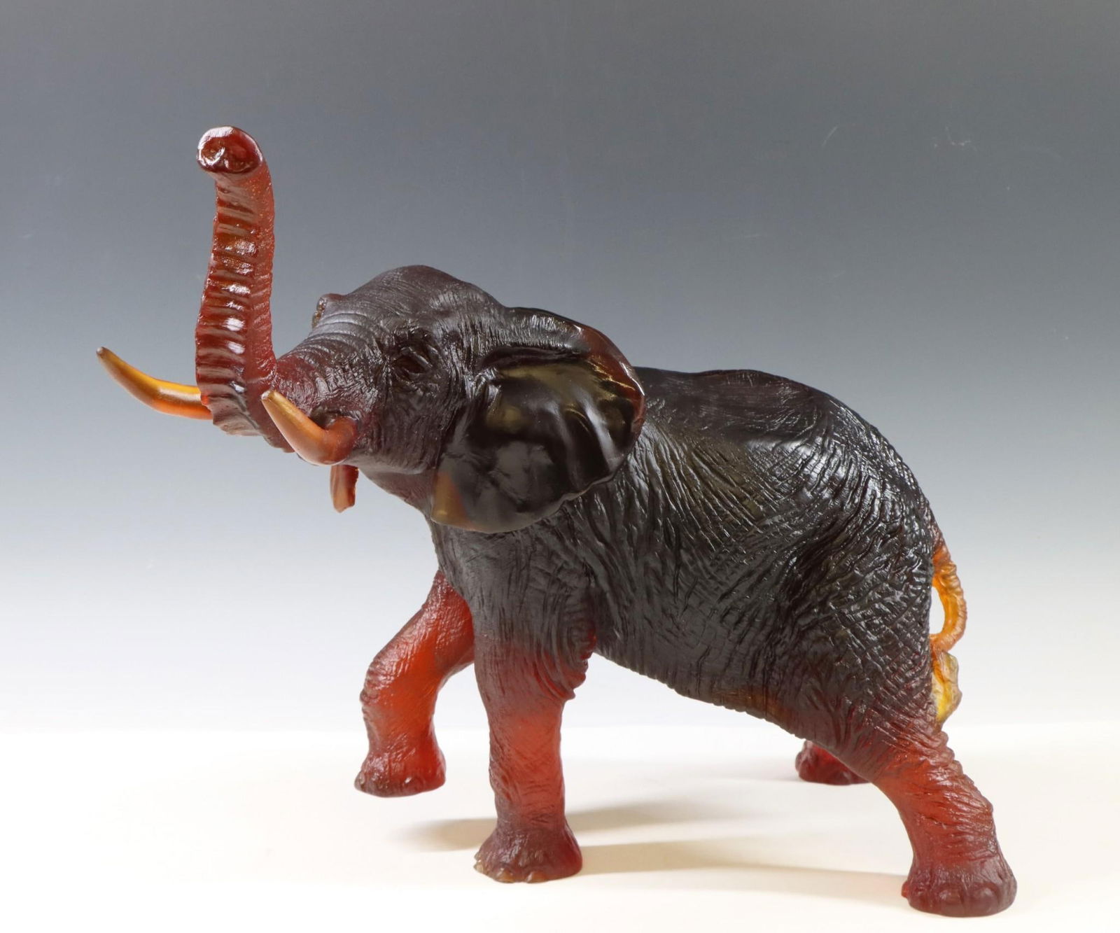 Jean-Francois Leroy for Daum Pate de Vere Glass Elephant: Dark amber "Elephant" glass paste sculpture, signed "Daum France" to one leg and impressed "Leroy" to another leg. One tusk has been professionally restored by A.L. Klein and Co. 12.75"h x 10"w x 14"d