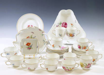 KPM and Meissen Porcelain Dishes: German porcelain dishes decorated with sprigs of flowers and butterflies in assorted patterns. KPM teacups (6), coffee cups (6), dessert bowls (9), a triangular serving dish, and a leaf form bonbon di