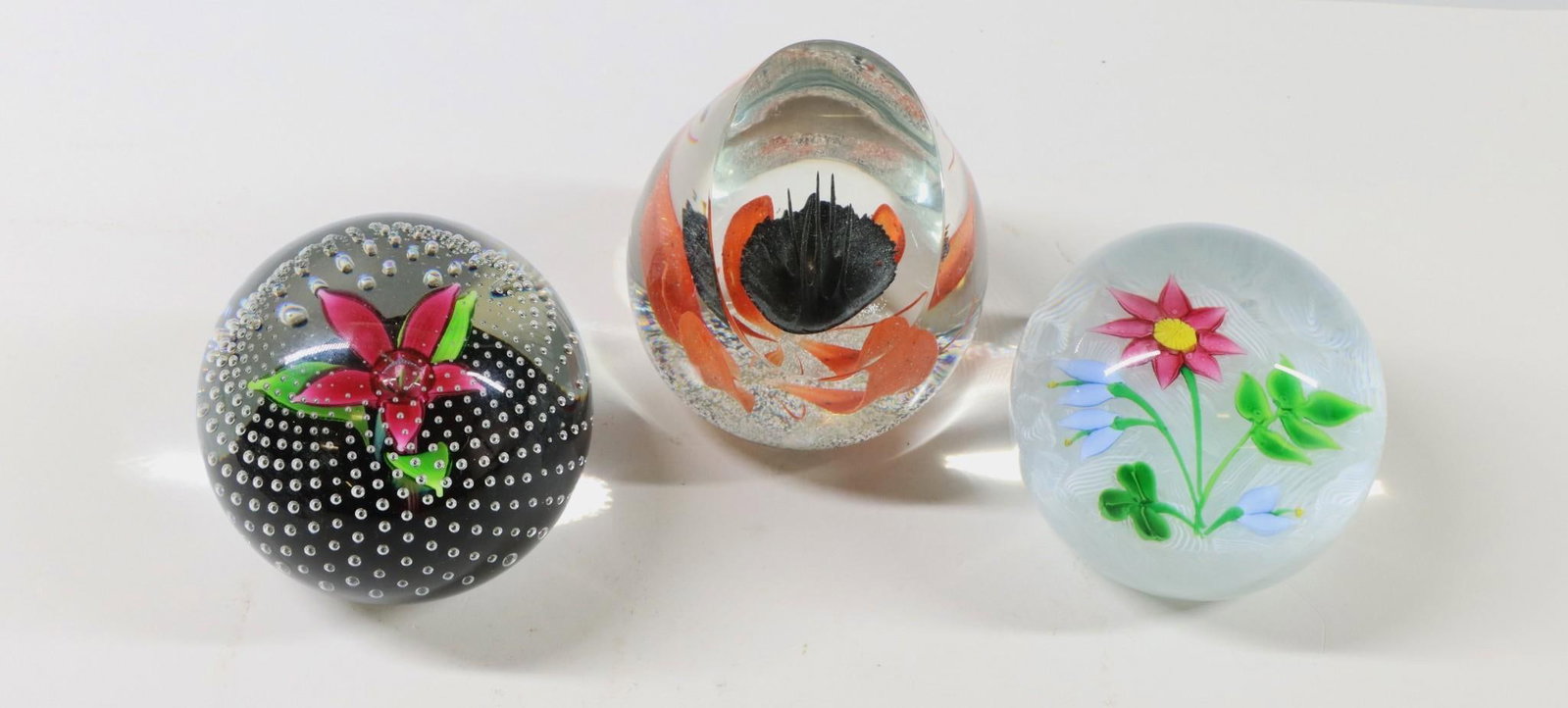Caithness Art Glass Paperweights: Scottish art glass paperweights (3), round and abstract pieces using lampwork, filigrana, and bubble techniques, including "Flower in the Rain", "Irish Bouquet" (71-150), and "Radiance" (435/650). Siz