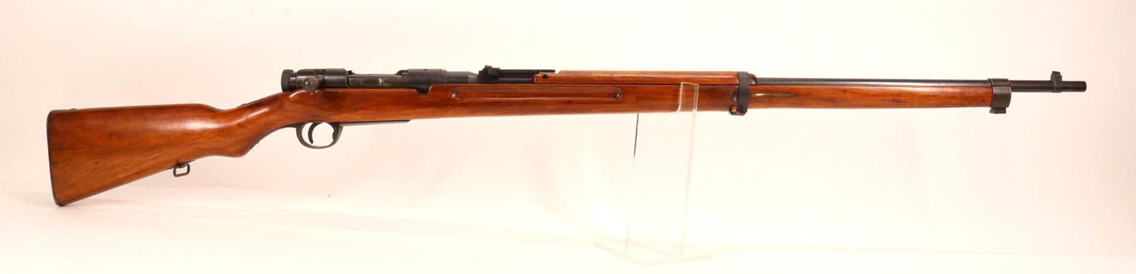 Japanese Tokyo Type 38 Arisaka Bolt Action Rifle: 6.5 Jap, 31" bbl, SN 1648657. 80% blue finish shows scattered freckles and small areas of oxidation and loss on floor plate, good bore, good mum, flip up rear ladder sight, wood stock and handguards s