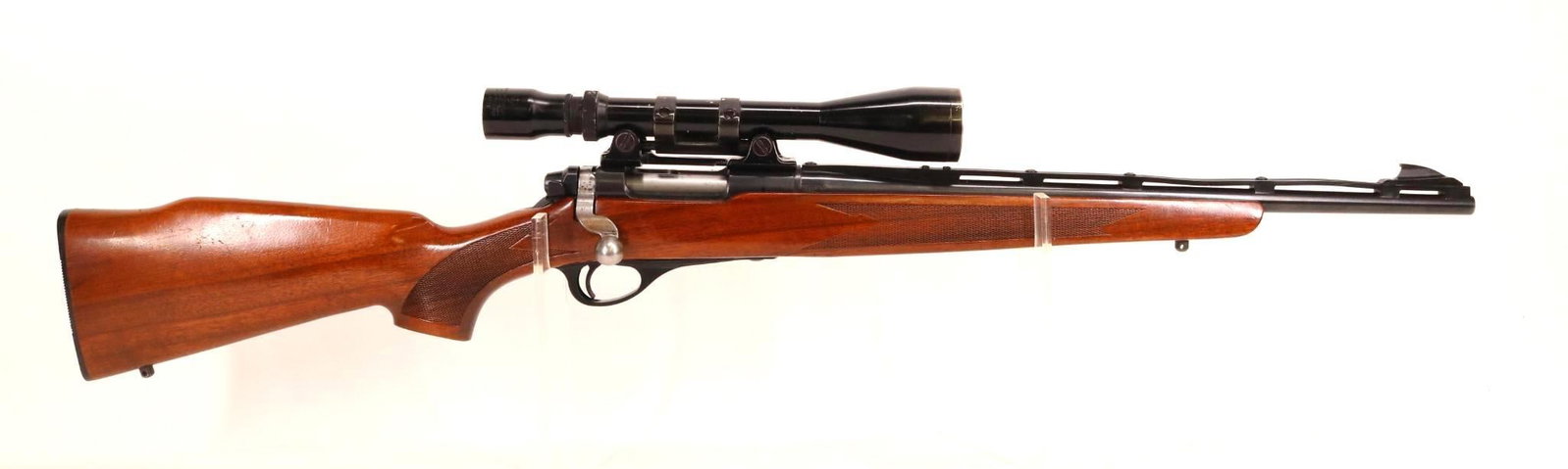 Remington 600 Bolt Action Rifle: 222 Rem, 18 1/2" bbl, SN 4099. 98% blue finish shows light handling, good bore, round barrel with screwed on nylon vent rib, rib has taken a set/bend at 2 places from being stored against another obje