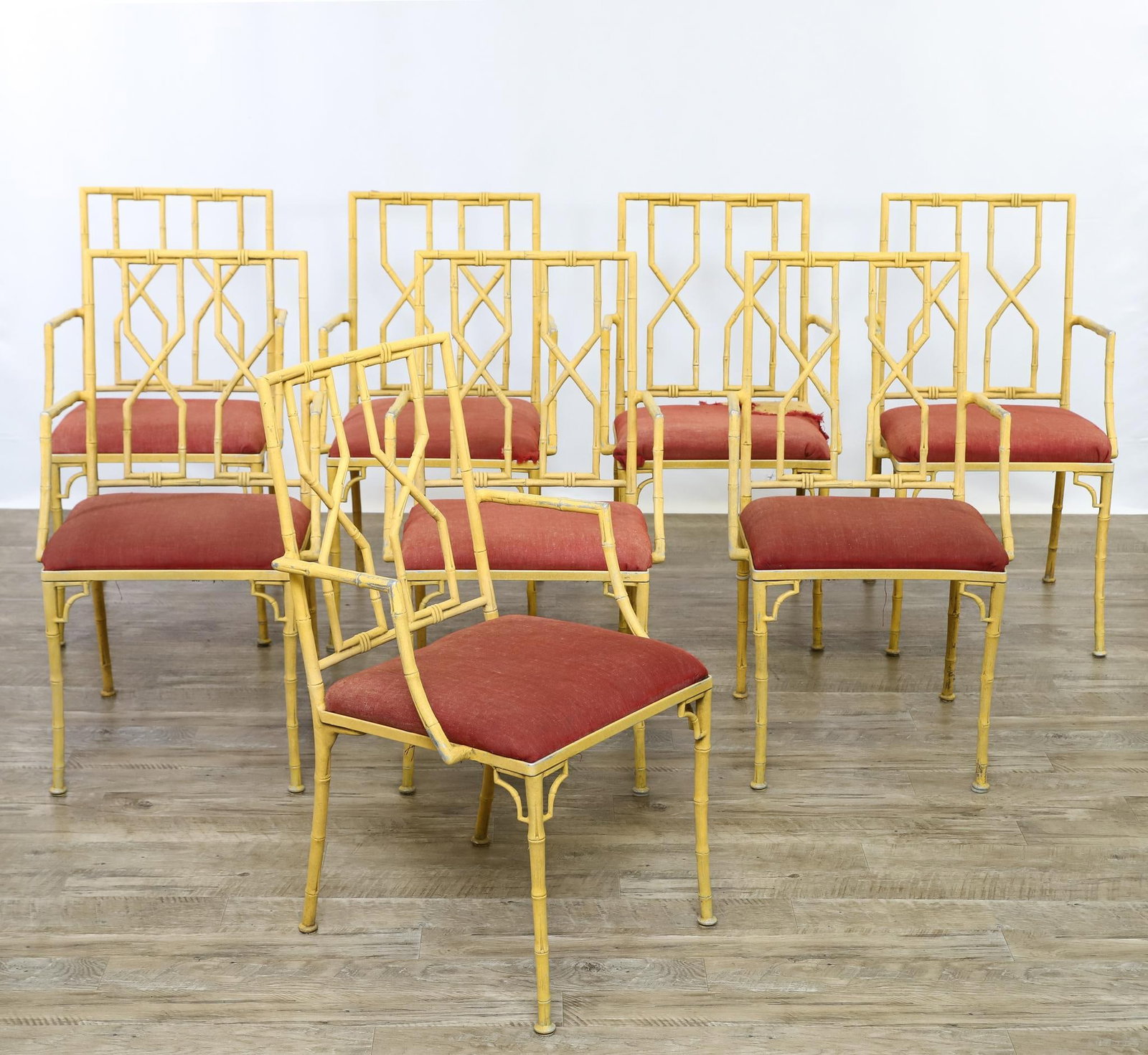Molla Patio Chairs: Cast aluminum faux bamboo armchairs, unmarked. Set of (8). The seats are detached, and there are tears and other wear to the upholstery. 35”h x 20”w x 20”d, seat height 17.5”