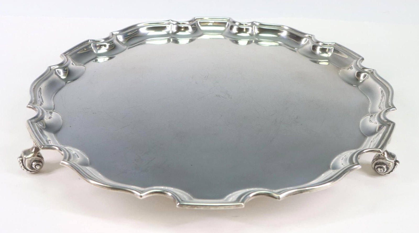 Mid-Century British Sterling Silver Salver: British sterling silver salver with a scalloped rim and scrolling acanthus feet, London, 1970, by Wakely and Wheeler. 1.25"h x 12"w x 12"d and 27.43 ozt