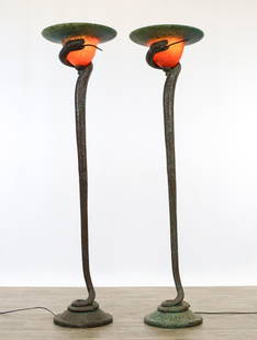 After Edgar Brandt "La Tentation" Torchieres: Art Deco style bronze torchiere floor lamps, a pair, each in the form of a snake rising from a basket and cradling a cased mottled orange and green pate de verre glass shade in the manner of Daum. No