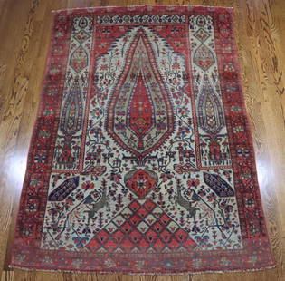 Antique Persian Carpet: Hand woven wool carpet, directional carpet, with stylized lion taking down a deer, birds and flowers, (fading, end loss) 72"x49". Family Room.