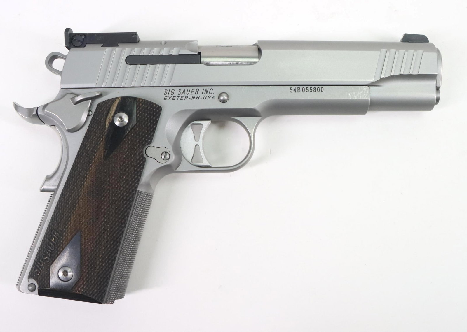 Sig Sauer 1911 Semi Automatic Pistol: 9mm, 5" bbl, SN 54B055800. Matte stainless shows only a few light scuffs, good bore, adjustable 3 dot sights, skeletonized hammer and trigger, checkered wood grips show no handling, No magazine. Excel