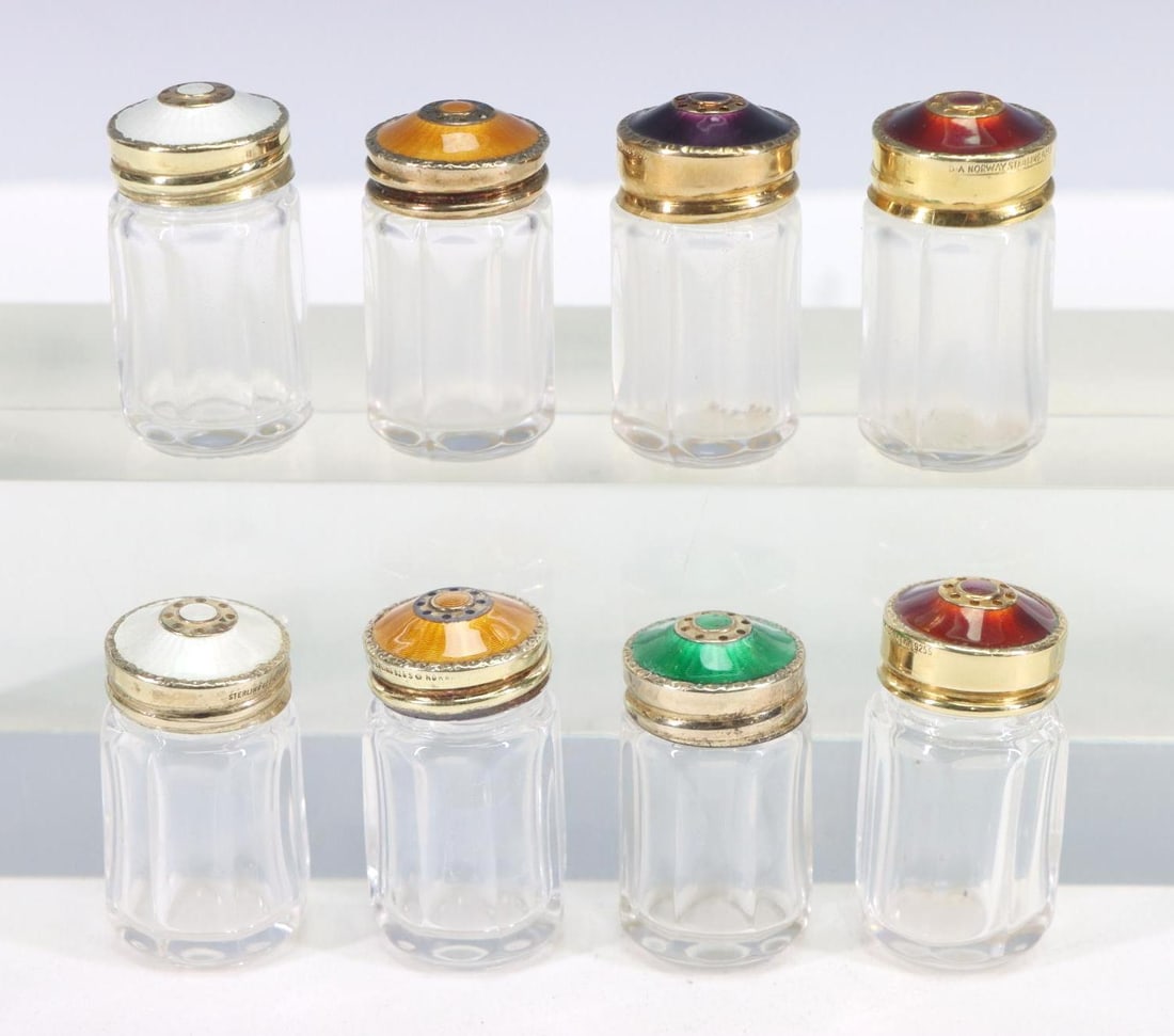 Norwegian Guilloche Sterling Silver Shakers: David Andersen and Hroar Prydz, complementing individual shakers with guilloche enameled and gold washed sterling silver covers on pressed glass. 1.5"h. (8) pieces. Covers 1.03 ozt