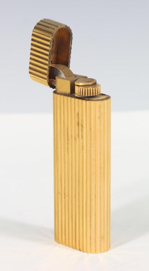 Cartier Lighter: Cartier gold plated lighter with fluted design.