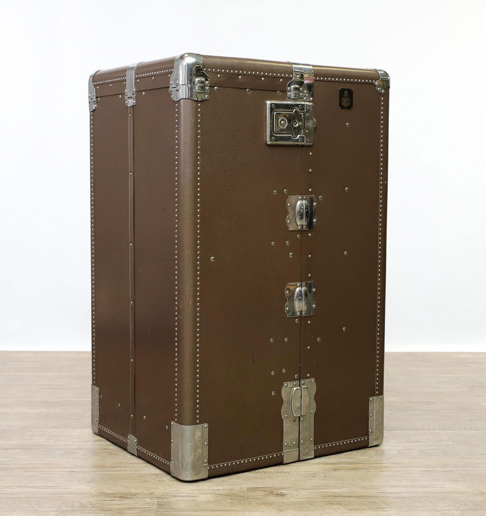 Mark Cross Wardrobe Trunk: Beige leather and chrome trunk which opens to five graduated drawers on one side, and a hanging rail with dust curtain over a shoe compartment on the other side. No keys. Scuffs and other wear. 25.25"