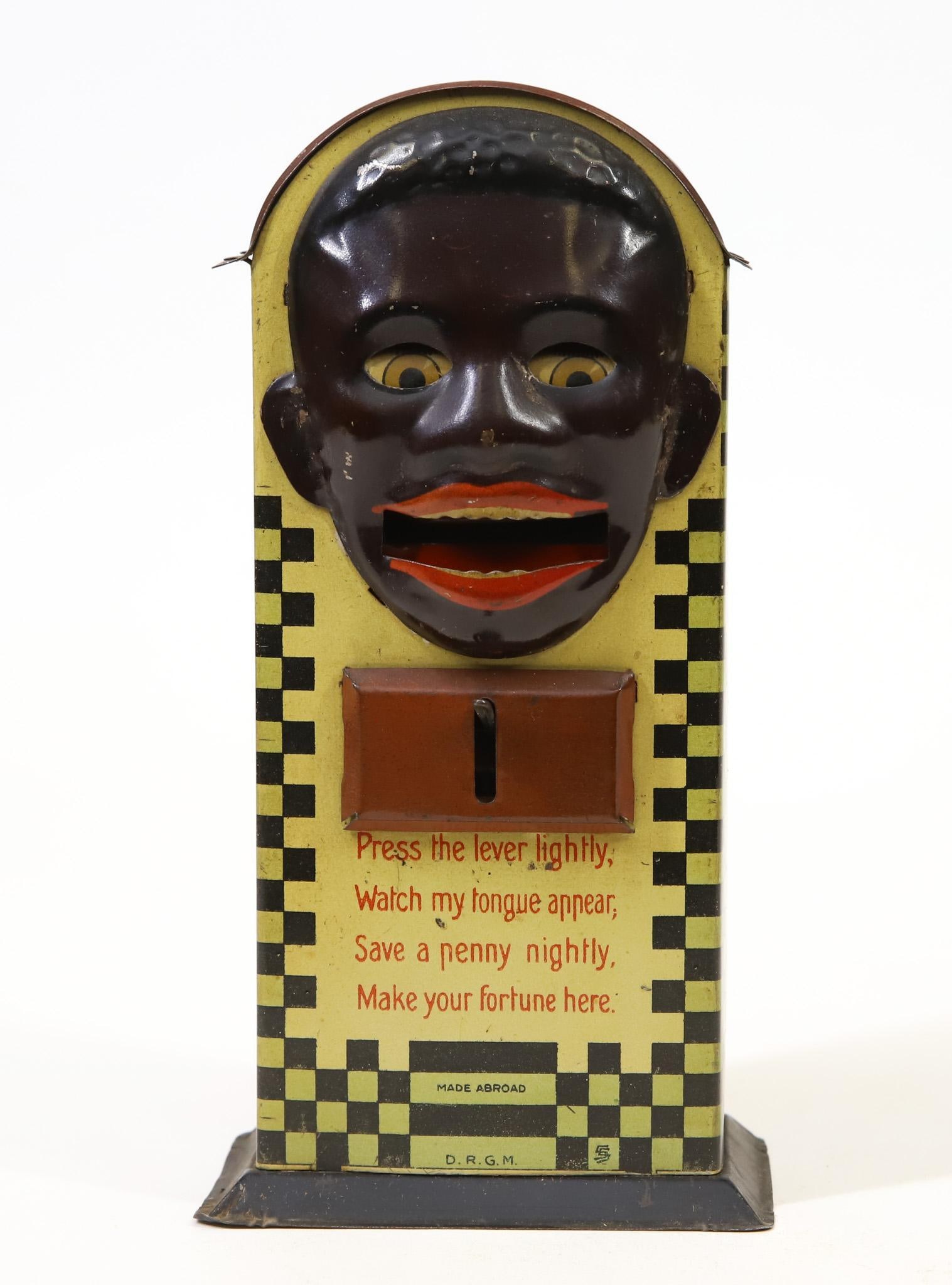 Saalheimer & Strauss "Minstel Type 1" Mechanical Bank: Saalheimer & Strauss, Germany, tin lithograph mechanical bank, feature black gentleman, put coin on protruding tongue and it goes into bank, in working order, 7"h x 3.5"w base.