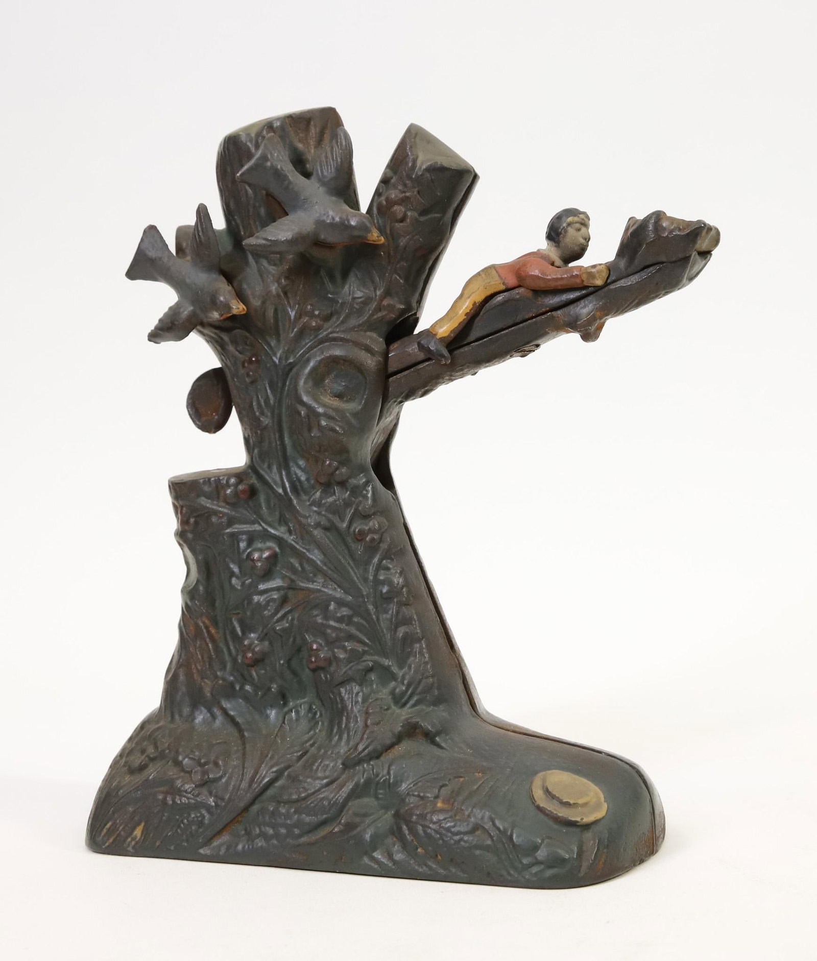 "Boy Robbing Birds Nest" Mechanical Bank: "Boy Robbing Birds Nest” cast iron mechanical bank, retains much of original paint, birds slightly loose, in working order, 7.5"h x 6"w base.