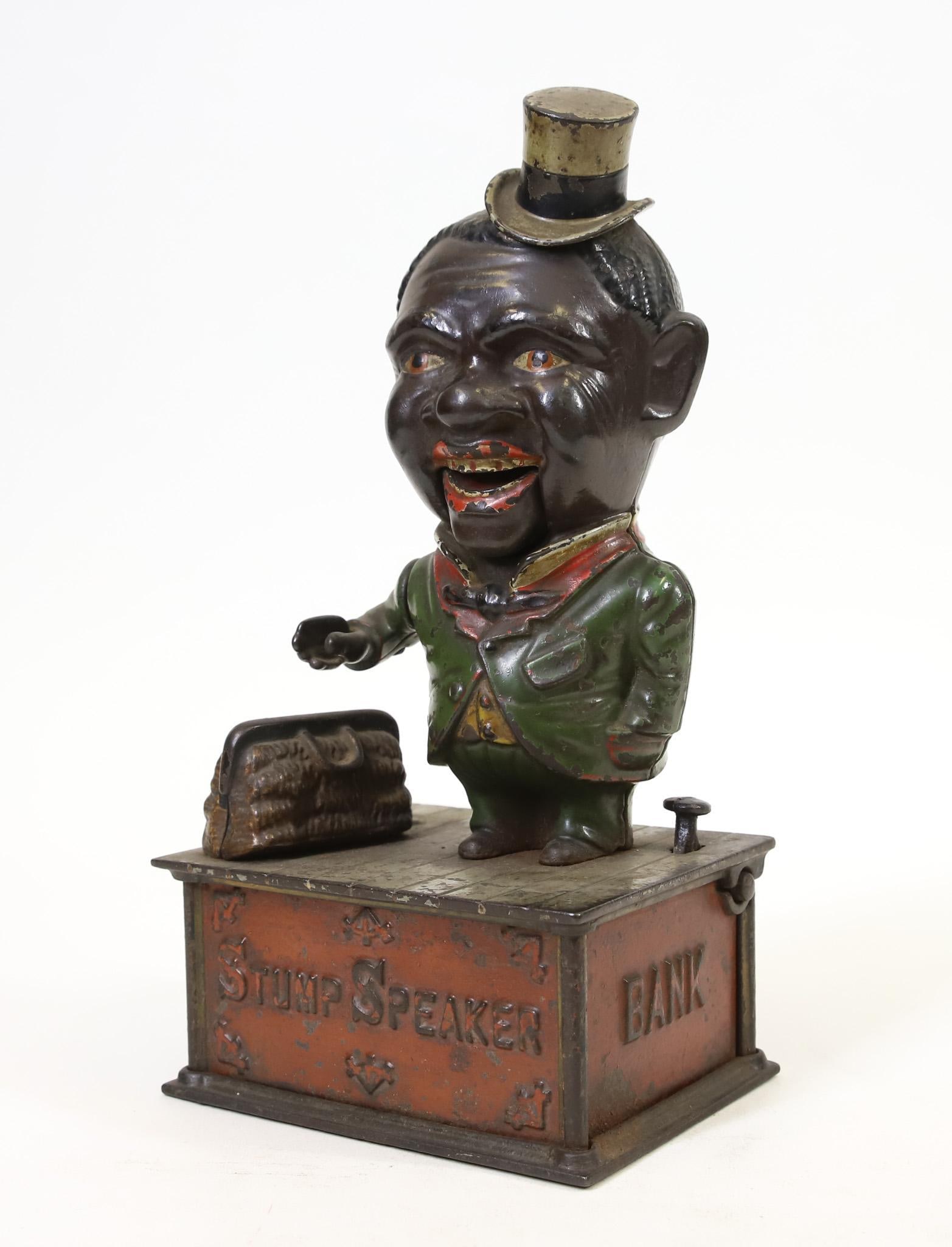 Shepard Hardware "Stump Speaker" Mechanical Bank: Shepard Hardware Company "Stump Speaker" cast iron mechanical bank, retains much of original paint, locking panel on back in tact, replacement screw on base, in working order, 10"h x 5"w base.
