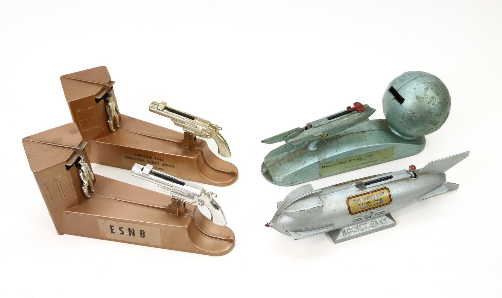 Mechanical Bank Grouping: "Strato Bank" space-themed, cast metal mechanical bank, place in base to also add bills, label for Houston Bank & Trust, in working order, some oxidation, 3.25"h x 7.5" w base. "Rocket Bank" cast meta