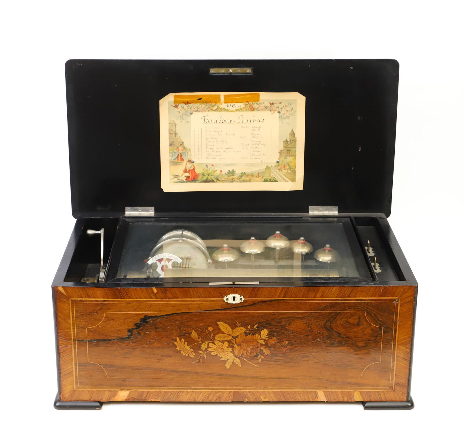 Swiss Orchestral Cylinder Music Box: Rosewood case with marquetry floral decoration and inlay banding, single comb, 10 airs, serial no. 1874, with drums and bells. Picard lithographic music card dated 1874 mounted under the cover. Winds