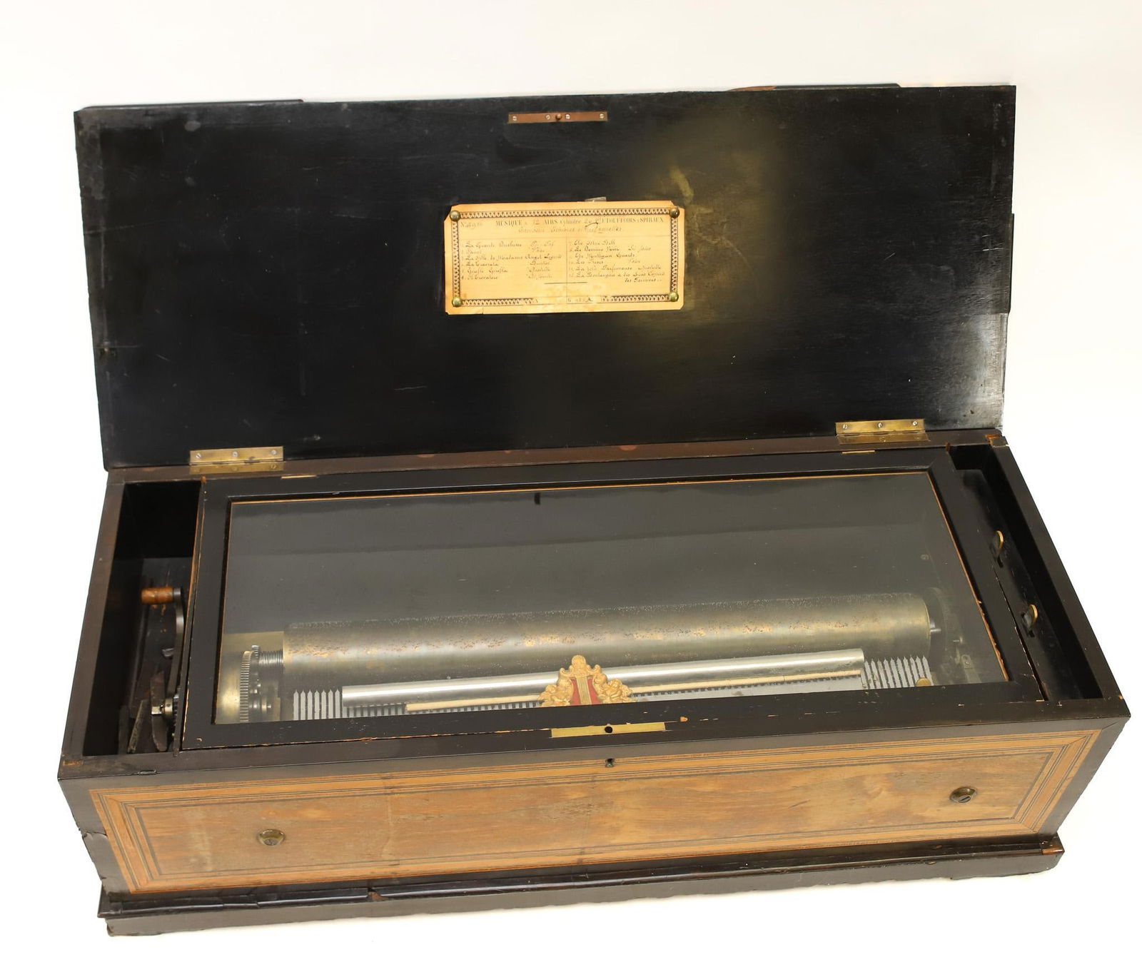 Swiss Orchestral Cylinder Music Box: Mahogany case with marquetry musical instrument and floral decoration and inlay banding, single comb,12 airs, serial no. 45916, with drums, bells, and castanets, cylinder no. 20. Lithographic and hand