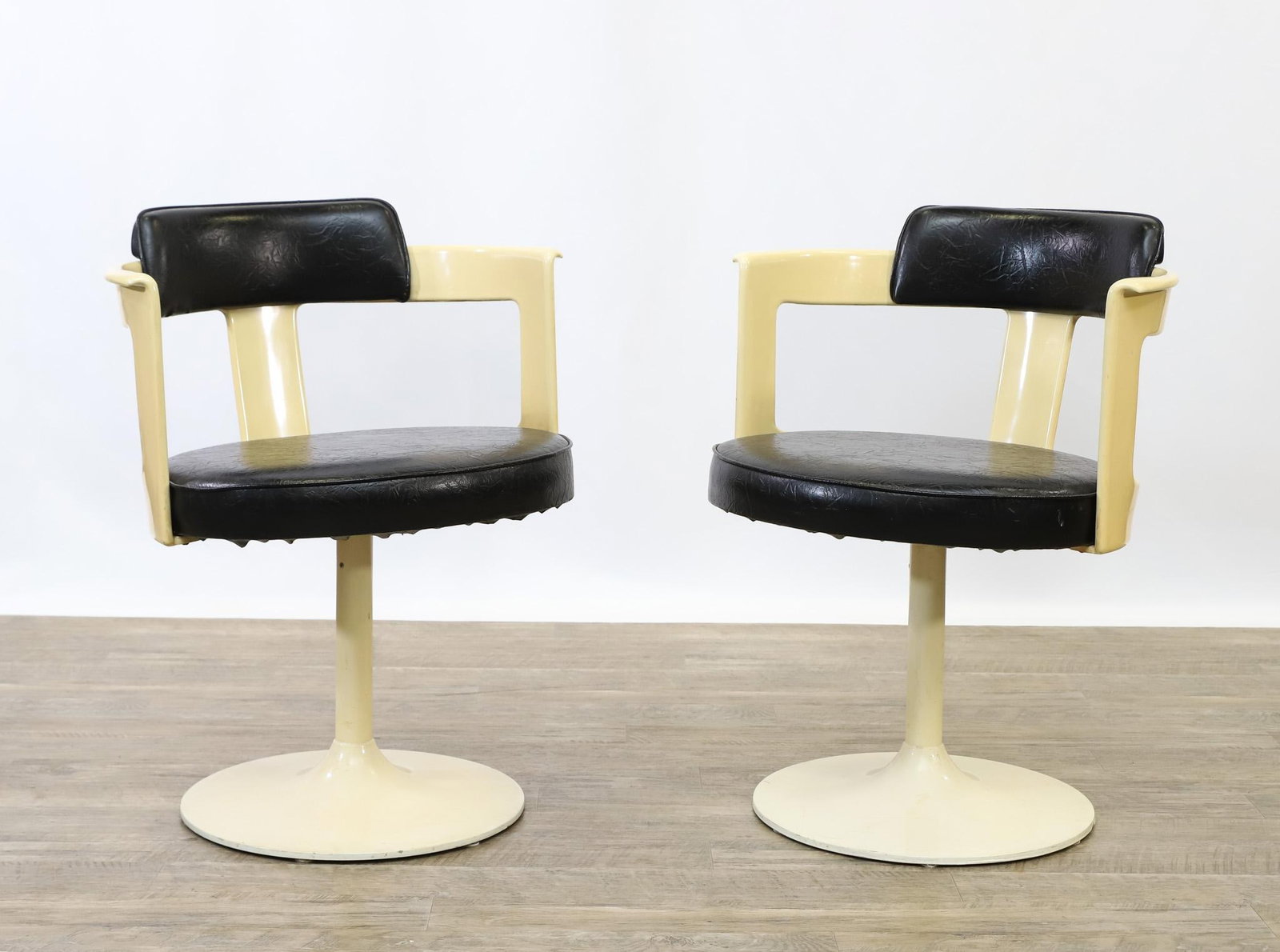 Daystrom Tulip Swivel Chairs: Barrel form pair of swivel armchairs with aluminum and steel bases, molded fiberglass and vinyl seats and backs, unmarked. 29"h x 23"w x 21.5"d, seat height 18"