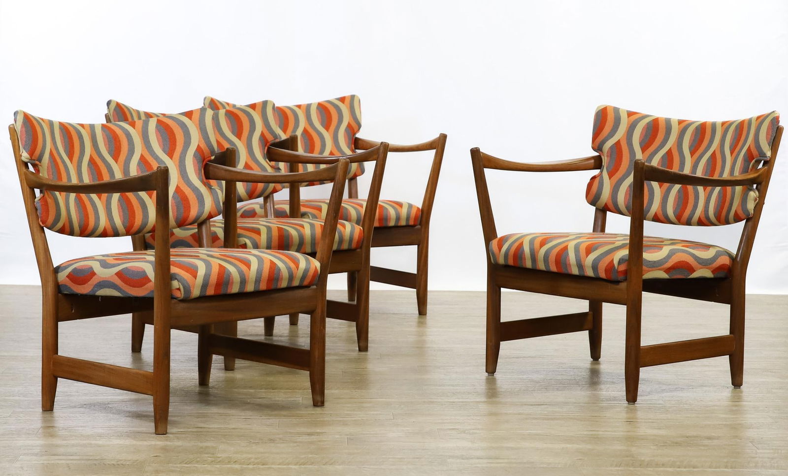 Fredrik Kayser and Adolf Relling for Dokka Mobler "Kaminstolen" Chairs: Norwegian teak "Kaminstolen (Fireplace)" armchairs, a set of (4), with shaped arms, boomerang cigar stiles, side stretchers, and polychrome wave upholstery, labeled. 28"h x 28.25"w x 24"w, seat height