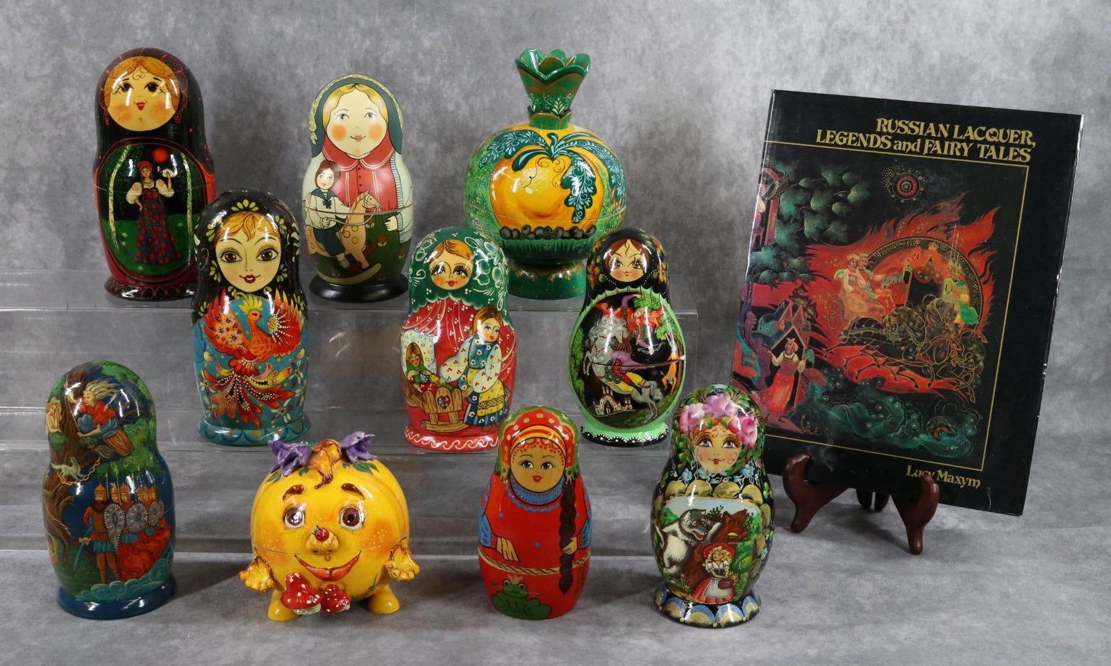 MATRIOSKAS.: LOT of (10) wooden Matrioskas story collection and book. Matrioskas - Firebird, Golden Cockerel, Frog Princess, Red Riding Hood, The Giant Turnip with base, The Kolek. Most are signed, Made in Russia.