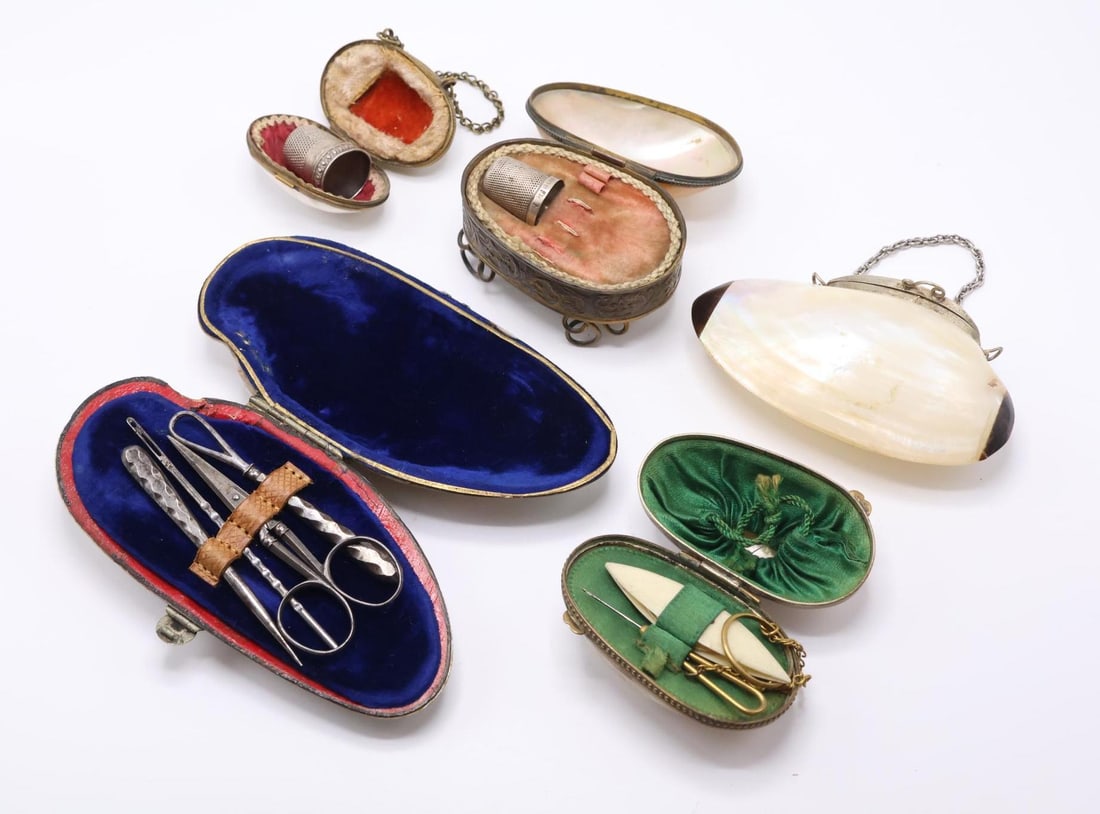 Mother of Pearl Etuis: Velvet lined mother of pearl shell etui with sewing tools including bodkins, sewing awl, and scissor. Mother of pearl shell with green satin lining containing a bone tatting shuttle and hook with draw