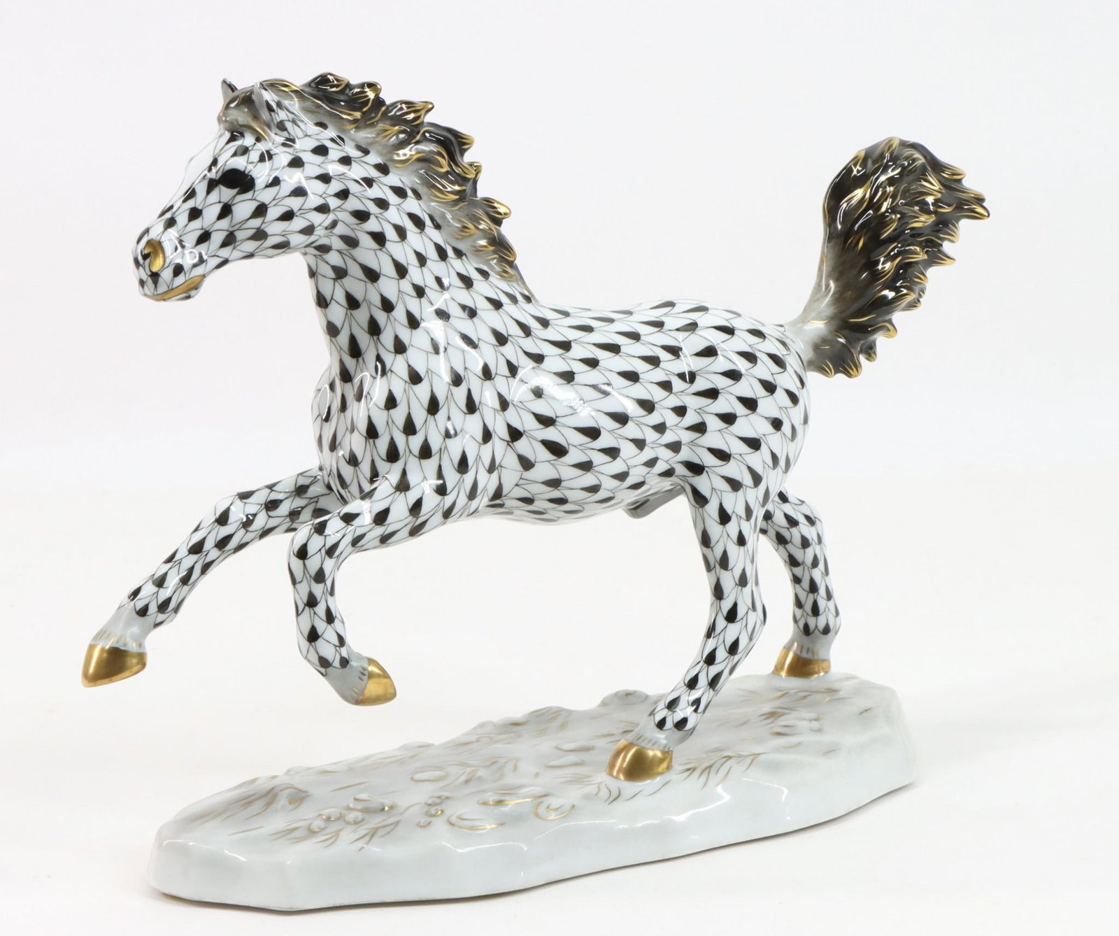 Herend Porcelain Kingdom Classic "Galloping Stallion" Figurine: Hungarian porcelain figurine, "Stallion Galloping", in black fishnet. 7.25"h x 3.5"w x 10"d