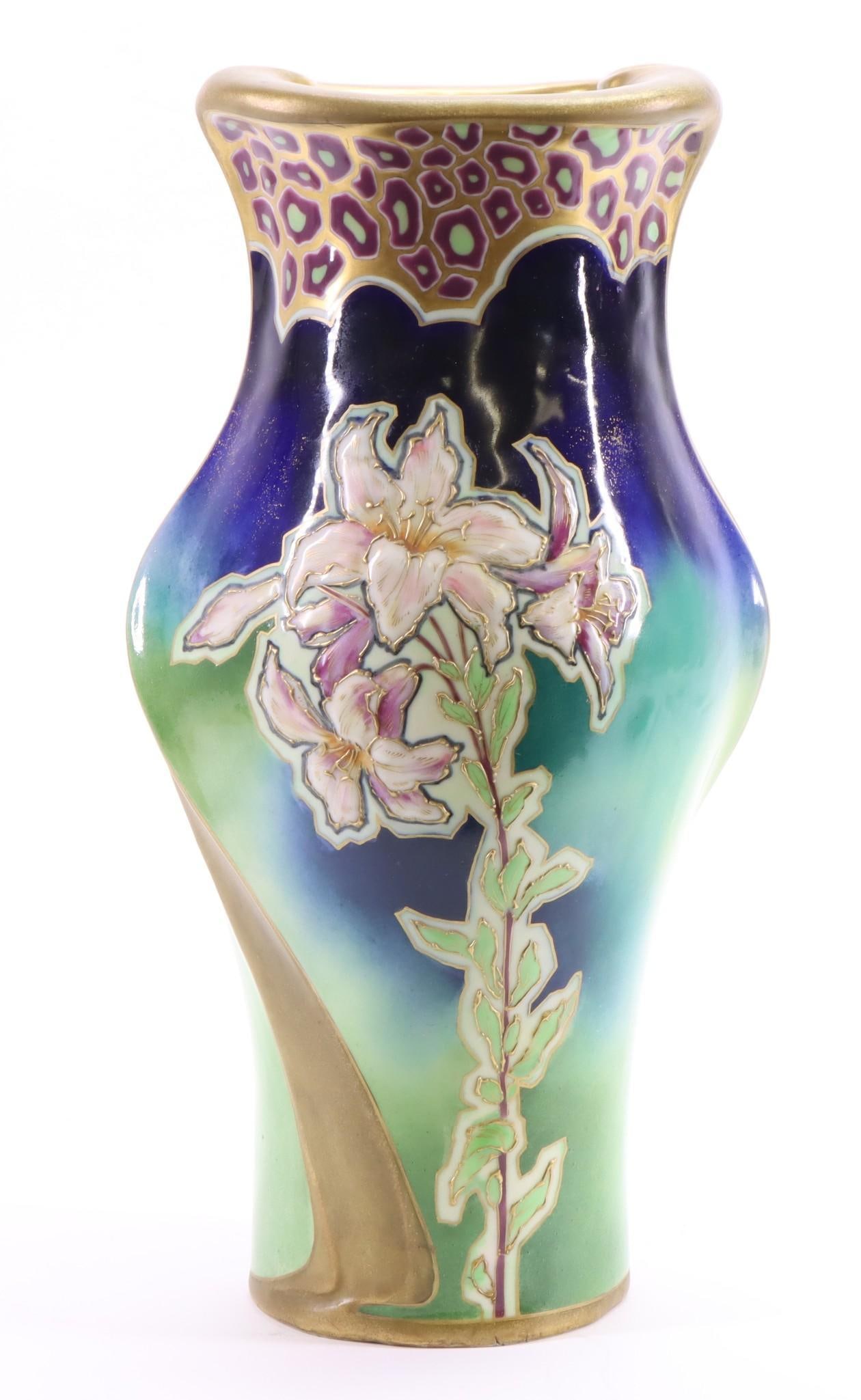 RStK Amphora Pottery Vase: Jugendstihl / Austrian Art Nouveau vase decorated with lilies, in a blue, green, and violet glossy glaze with gilding, marked for Riessner, Stellmacher & Kessel. 14.25"h x 6.75"w x 5.5"d.