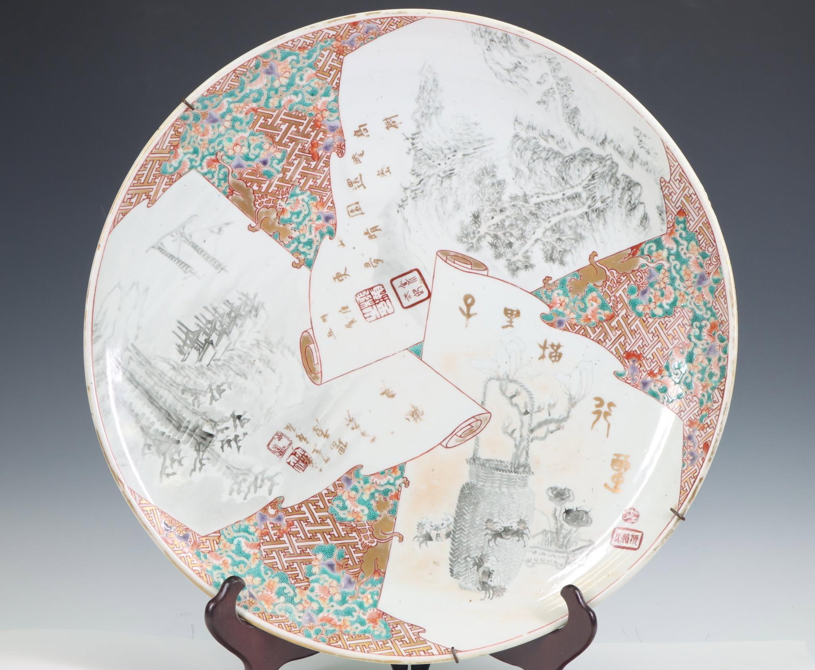 Japanese Arita Porcelain Charger: Meiji era large charger with grisaille decoration featuring crabs in a basket and landscapes, with gilt accents and markings, and seal marks. 18.5"w