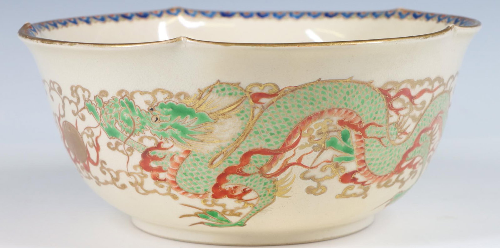 Gyozan Japanese Satsuma Pottery Bowl: Meiji era, dragon decorated serving bowl with folded rim, with gilt accents. 3.5"h x 8.25"w