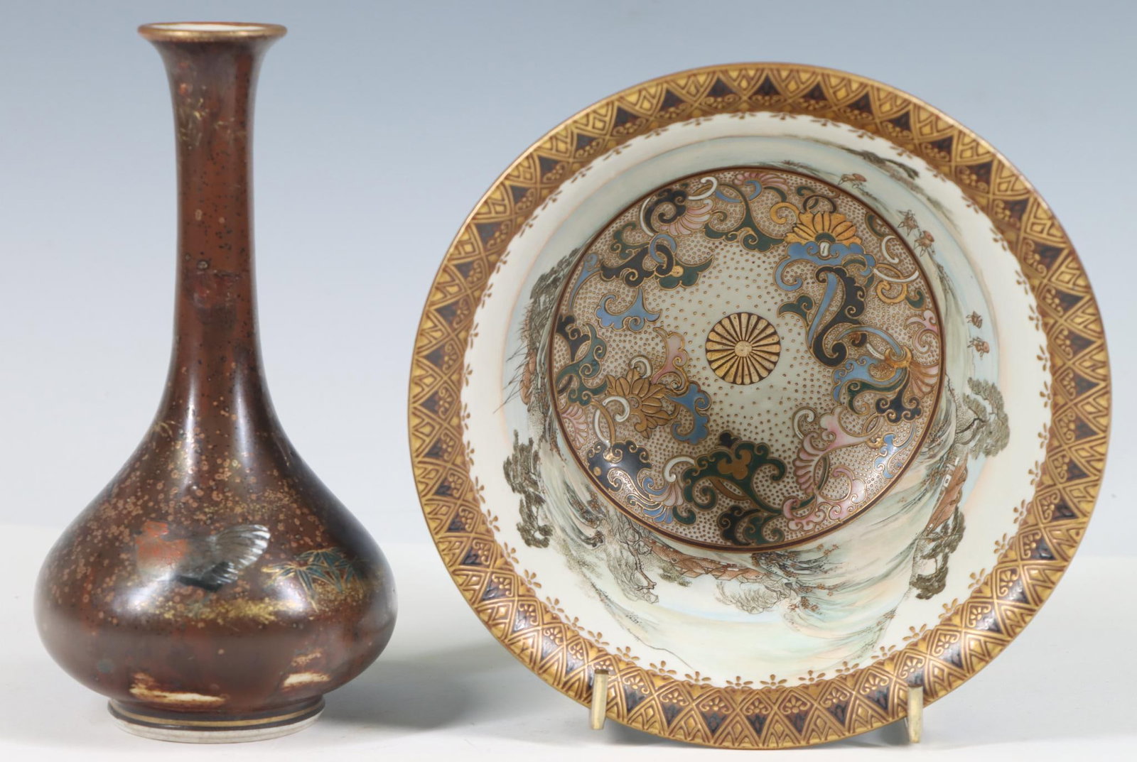 Japanese Kutani Porcelain Bowl and Vase: Meiji era wares. A Taniguchi rice bowl, the exterior decorated with gilt birds in flight on a black ground, the interior decorated with figures in a panoramic landscape and textured gilt Satsuma style