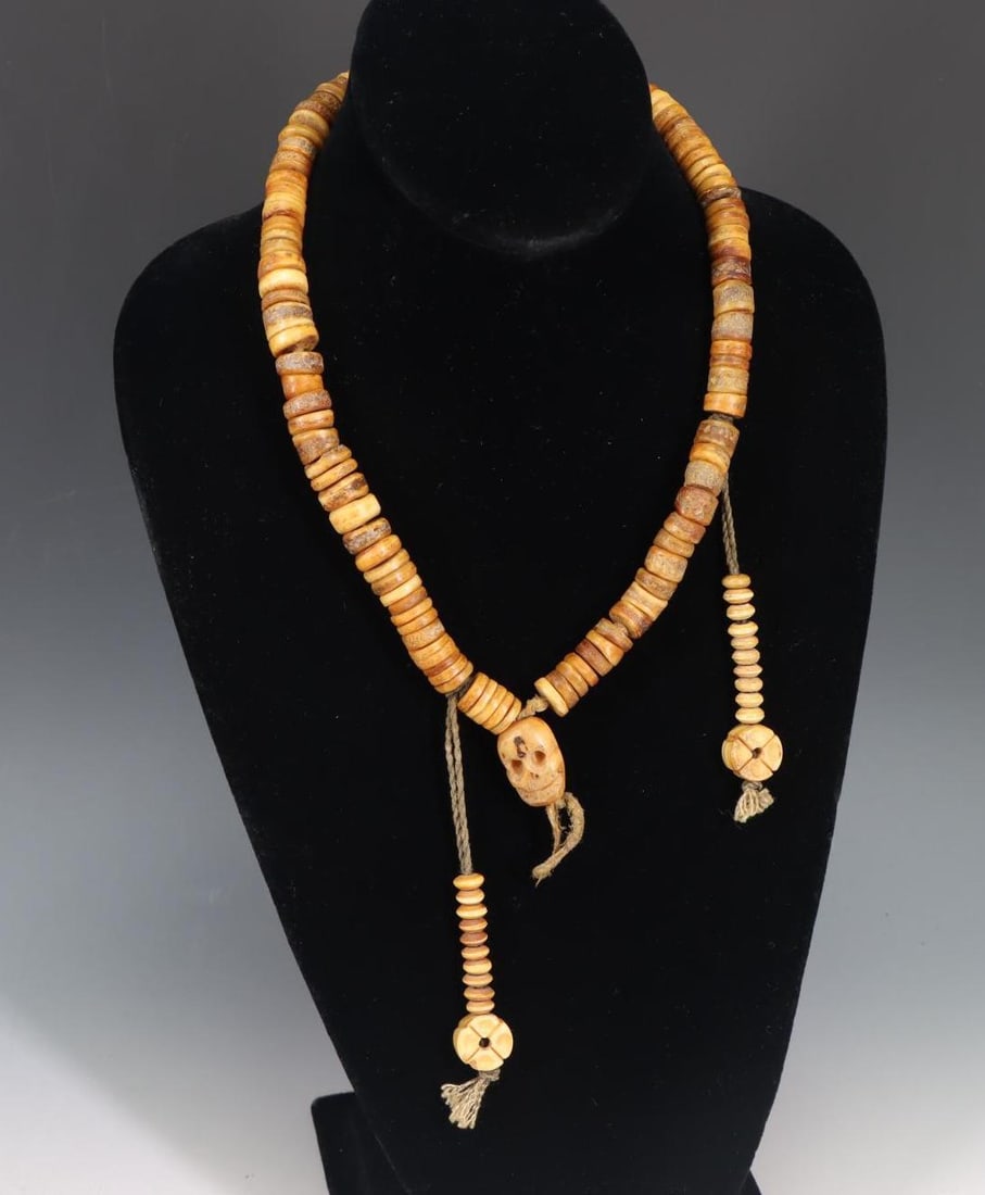 Tibetan Mala Bone Necklace: Tibetan mala necklace of carved bone with skull accent. Approx 20"