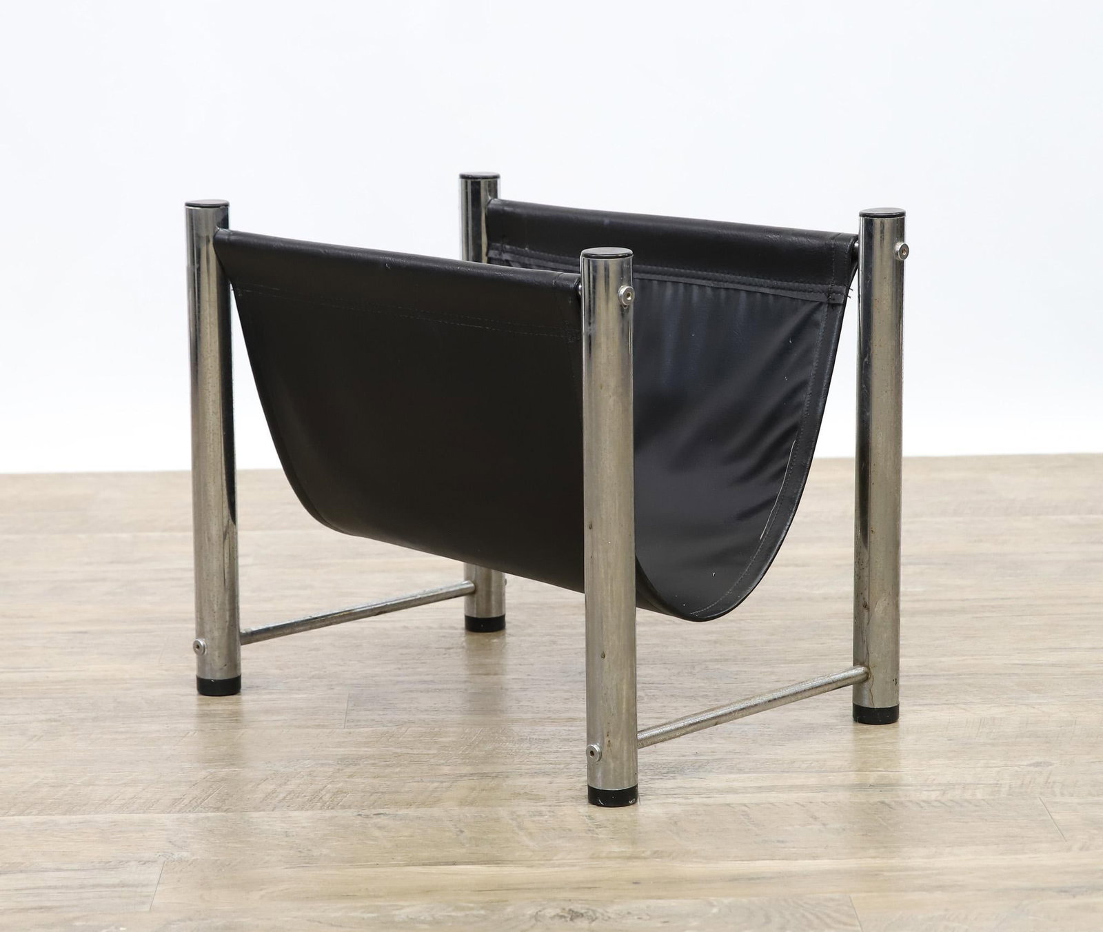 Chrome and Vinyl Magazine Rack: Sling magazine rack, black vinyl with a chrome steel frame. 15"h x 18"w x 13"d