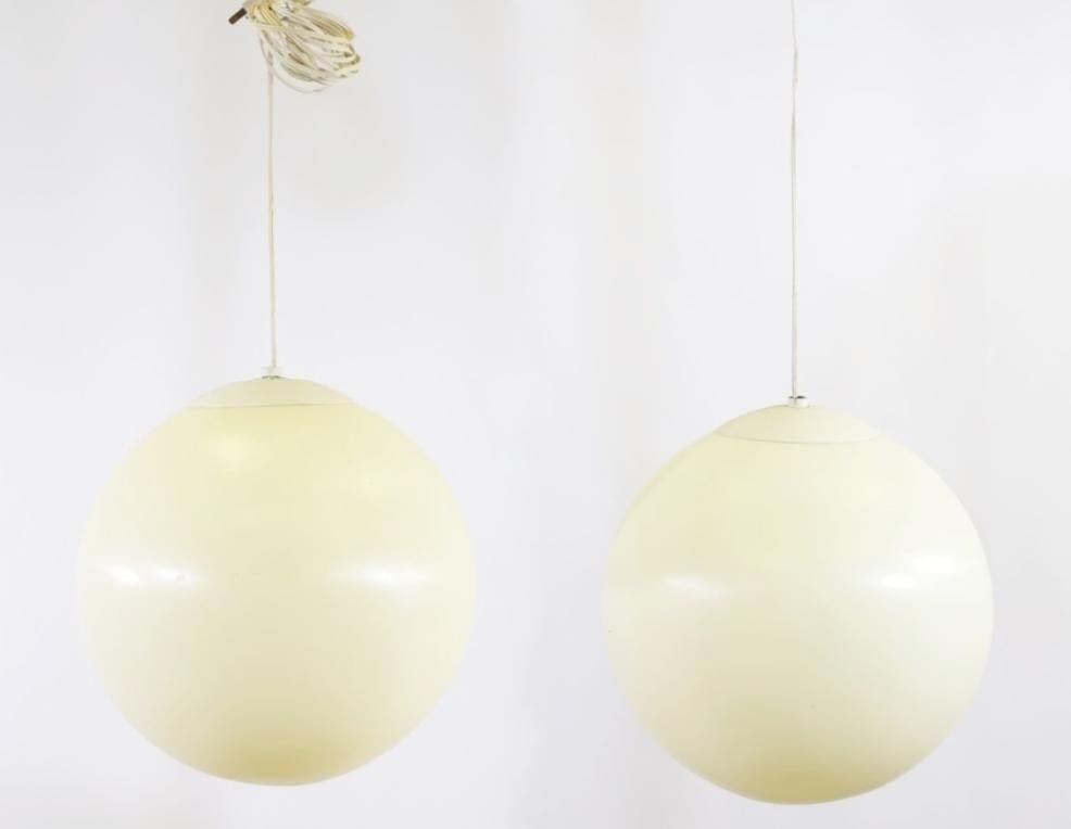 Robert Sonneman Style Orb Lamps: Molded plastic pair of orb form hanging pendants with enameled steel caps. One turns on; both need rewiring. Pitting to the metal and some discoloration. 13.5"w