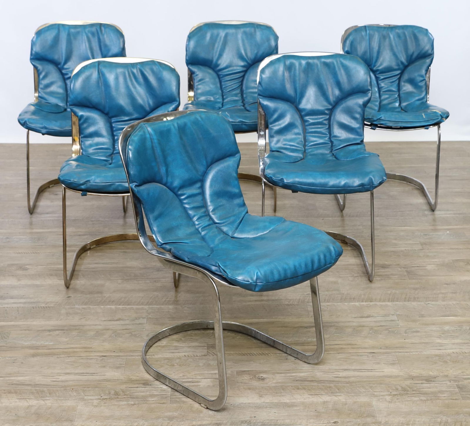 Willy Rizzo for Cidue Model C2 Chairs: Italian Modern chrome steel cantilevered side chairs with wire backs and seats and sky blue vinyl upholstered seat pads, labeled. Set of (6). Wear including pitting and tears. 31.5"h x 16"w x 21"d, se