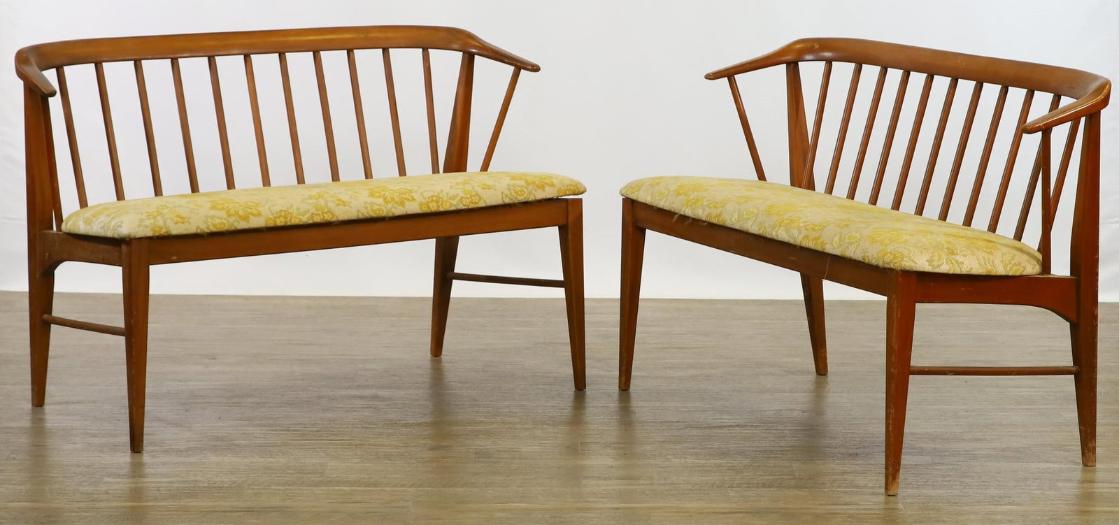 Walnut Benches: Spindle back pair of two-seat benches, with shaped rails, tapered square stiles and legs, round side stretchers, and upholstered seats. Wear including scuffs. 31"h x 44.5"w x 20.5"d